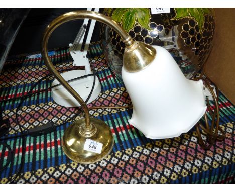 A small brass table lamp with glass shade.