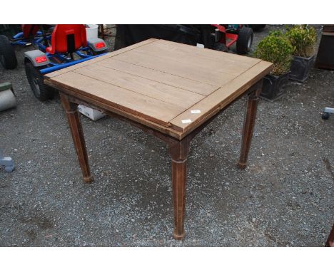 A light oak extending dining table, 36'' square (closed).