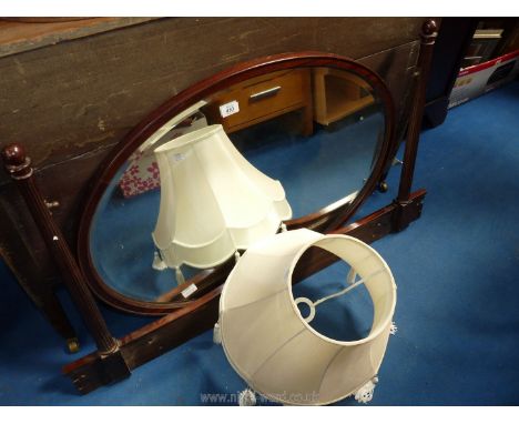 A large oval swing mirror for a dressing table with frame 45 1/2" W plus a cream fabric lamp shade.