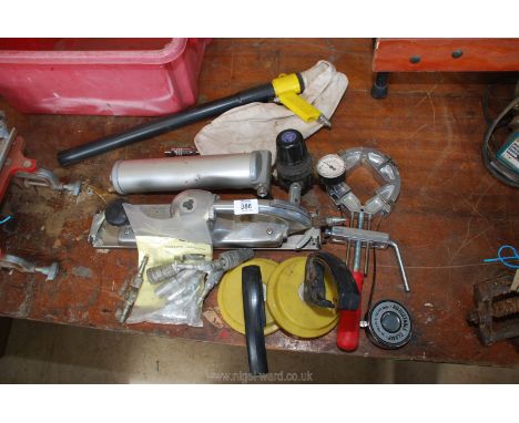 A pneumatic flat sander and adjustable clamp, miscellaneous pneumatic items and a metal banding machine.