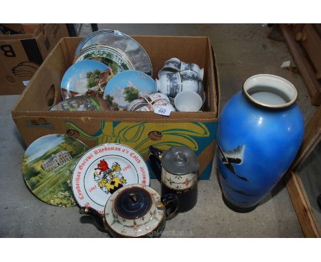 A tall vase, teapot, pictorial wall plates, cups and saucers.