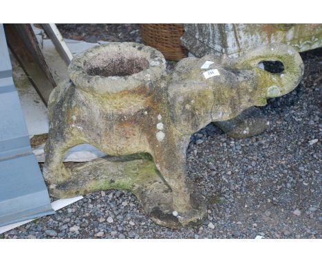 A concrete elephant planter.