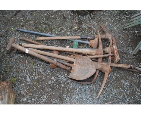 A quantity of tools, pickaxes, iron bar, whacker etc.