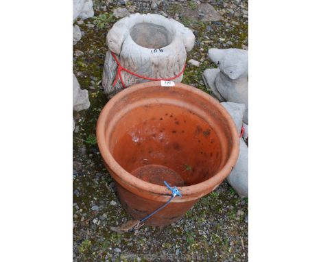 One terracotta plant pot and a concrete lion planter