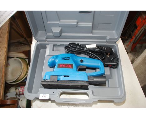 A cased Ryobi sander , as new.