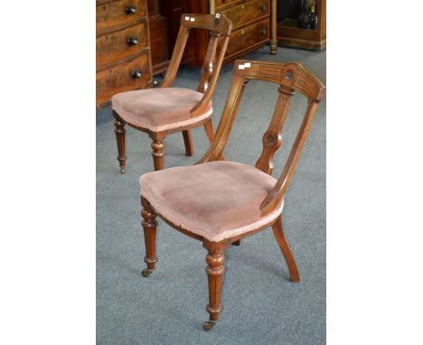 A pair of mahogany salon chairs, curved top rail, shaped and carved splat, stuffed-over seat, turned and reeded forelegs, cer