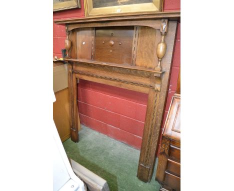 A 1940's oak fire surround, stepped mantel, turned columns, single shelf. 160cm high x 141cm wide.