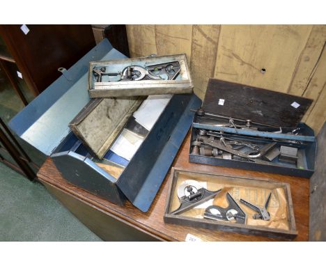 A wooden engineering cabinet and toolbox containing calipers, measures, etc.