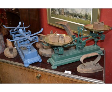 A set of early mid 20th century grocers scales, and another eleven grocer weights, an assortment of sizes, a cobblers iron, a