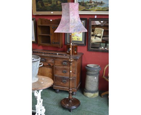 An early 20th century mahogany standard lamp, turned column, circular base, turned feet 