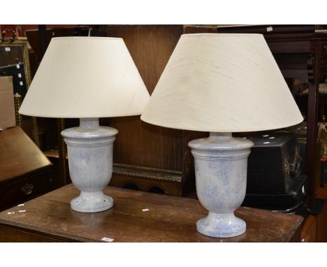 A pair of blue and white large urn shaped lamp bases, with shades 