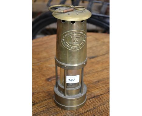 A miners lamp, E Thomas and Williams