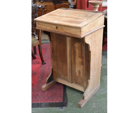 An oak schoolmasters desk, hinged top panel door cupboard to base 97cm high x 61cm wide 