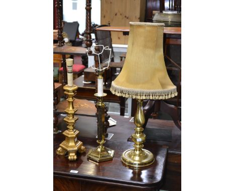 Two brass column table lamps; a wooden table lamp