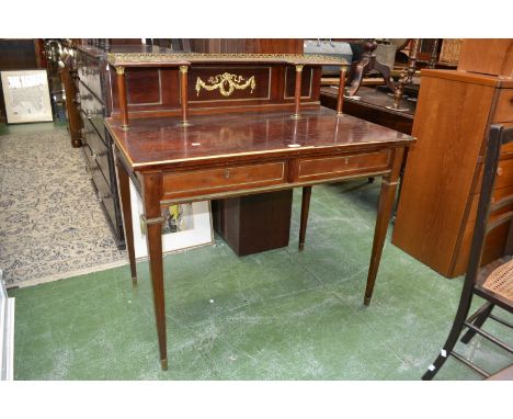 A Regency style writing desk, gallery with shelf supported by columns, two short drawers to frieze, tapering square supports,