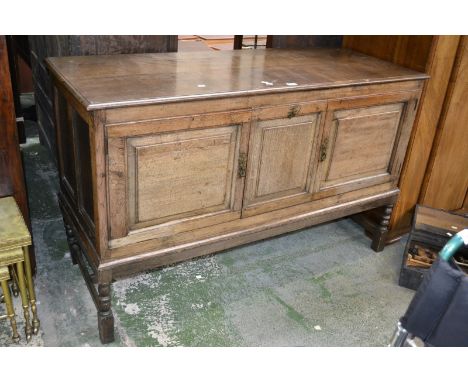 An oak sideboard, moulded top, two fielded panel doors, turned supports, early 19th century