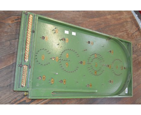 An early 20th century bagatelle board.