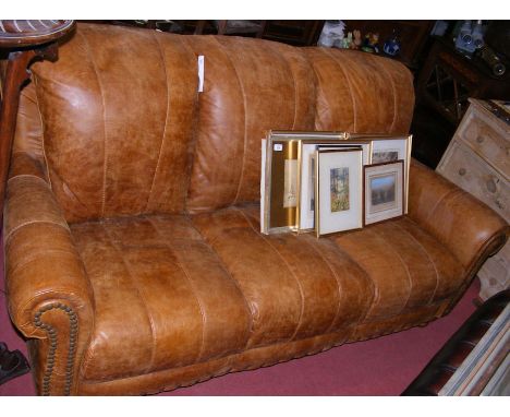 A Victorian style three seater brown leather settee 