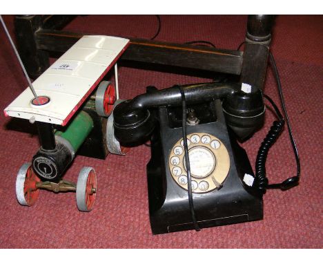 An old Mamod steam tractor, together with an old Bakelite telephone  