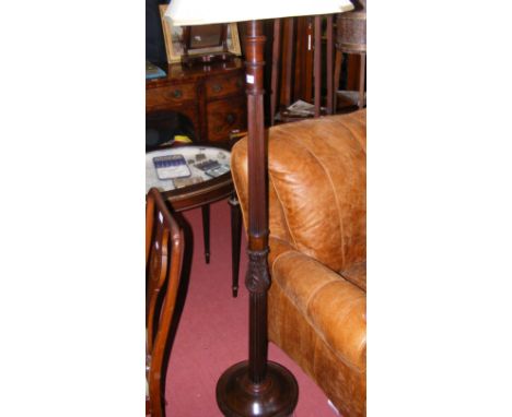 An old mahogany standard lamp with reeded and carved support 