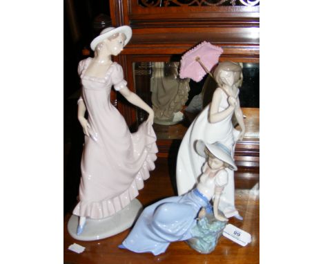 Lladro figure of lady with umbrella, together with two Nao figures 