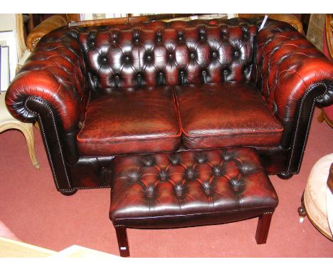 A Victorian style Chesterfield settee with matching stool 