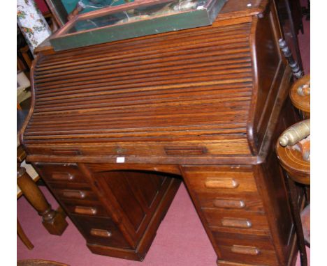 A Victorian roll-top desk with drawers below 