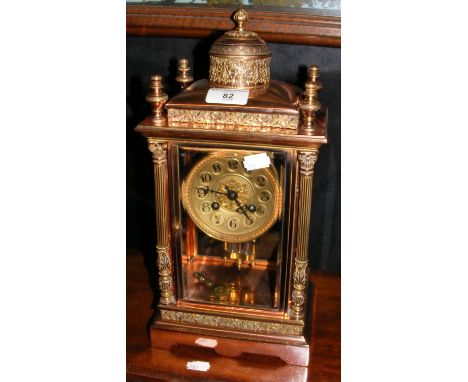 A decorative French mantle clock with chiming movement and embossed/engraved decoration - standing 36cm high 