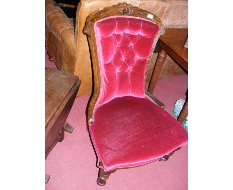 A Victorian nursing chair with button back and turned supports 