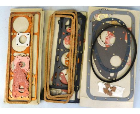 A TR4/A (1961 - 1967) engine gasket set, unused, together with another similar, various other gaskets and a fan belt.