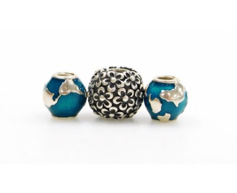Three silver charms, comprising a Pandora floral bead and two unmarked enamel globe beads, 18.6g all in. (3) 