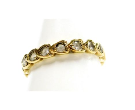 An eternity ring, with heart shaped pendants, each set with tiny diamond in a yellow metal setting, unmarked, ring size Q, 2.
