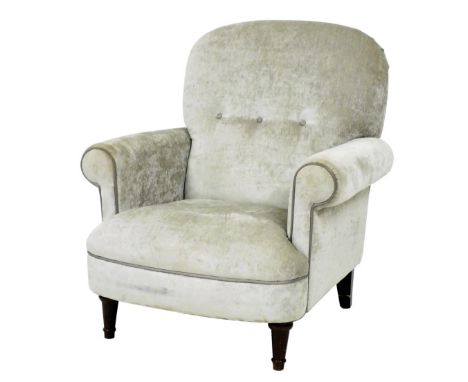 A DFS button back armchair, upholstered in overstuffed silver dralon fabric, raised on turned legs, 82cm wide.