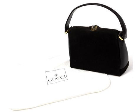 A vintage Gucci brown leather and suede top handle handbag, with gold and silver coloured turn lock clasp, the interior revea