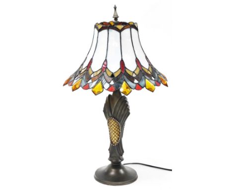 A Tiffany style table lamp, the shade with white, amber and red opaque panels, on a shaped column, 70cm high. 