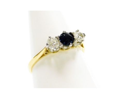 A sapphire and diamond three stone ring, with central round brilliant cut sapphire, in claw setting flanked by two diamonds e