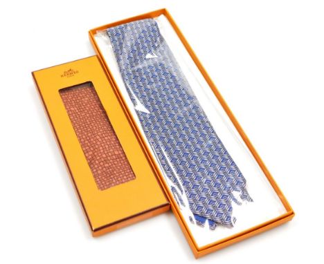 Two Hermes silk ties, comprising a blue tie with link design, and a red geometric pattern tie, both boxed.