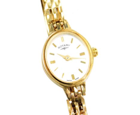 A Rotary 9ct gold lady's wristwatch, with a white enamel oval dial, 1.5cm wide, on a pierced design bracelet, 10.4g all in. 
