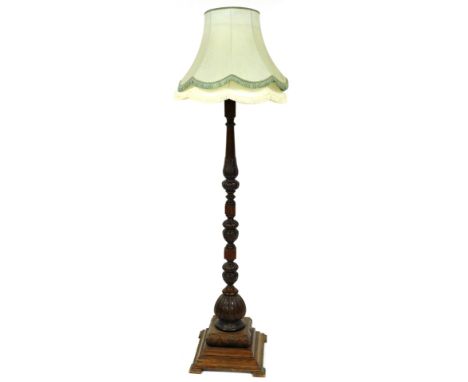 A Victorian oak standard lamp, with a turned and acanthus leaf carved column, raised on a stepped square base, with contrasti
