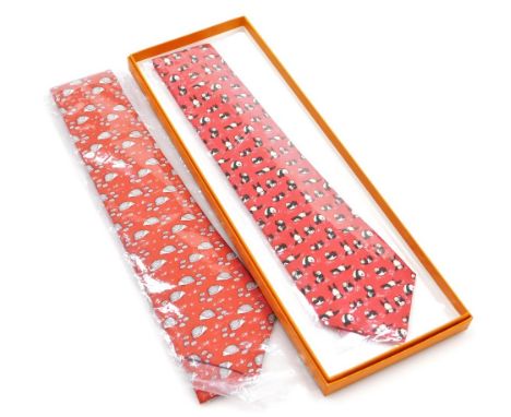 Two Hermes silk ties, comprising a red tie with hedgehog design, and a further red tie decorated with dancing pandas, one box