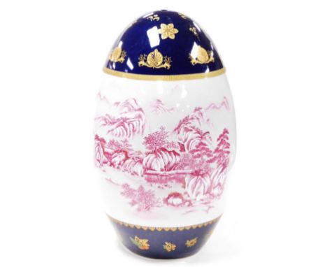 A 20thC Chinese porcelain sculpture, of ovoid form, decorated with an upper and lower blue glazed band with gilt highlighted 