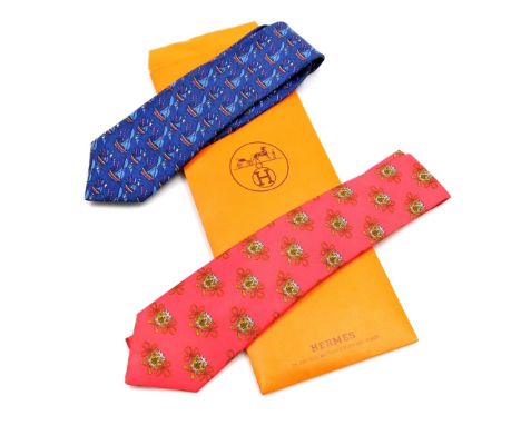 Two Hermes silk ties, comprising a blue tie with sailing boat design, and a red tie decorated with drums, contained in a Herm