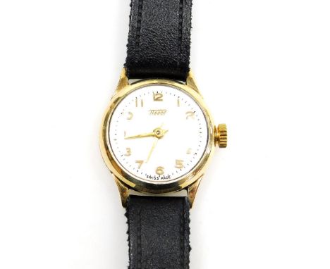 A Tissot 9ct gold lady's wristwatch, with small silvered watch head, in a 9ct gold casing, on a black leather strap, the dial