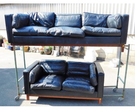 A Vatne Mobley black leather three seater sofa, and matching two seater sofa. (AF) The upholstery in this lot does not comply