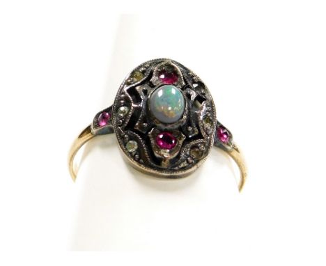 An Art Deco style dress ring, with oval shield set with topaz, opal and tiny diamonds, in a silver setting, on a yellow band 