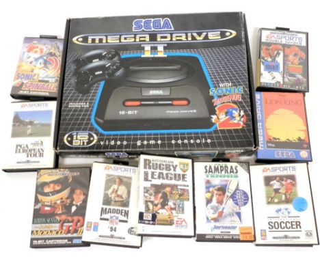 A Sega Mega Drive II video game console, with two control pads and Sonic the Hedgehog II game, boxed, and various games to in