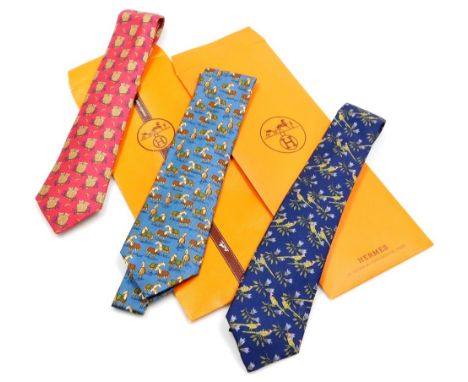 Three Hermes silk ties, comprising a blue tie decorated with pheasants, a further blue tie with horse design, and a red tie w