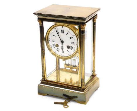 A late 19thC French brass cased mantel clock, the circular white enamel dial bearing Roman and Arabic numerals, eight day mov