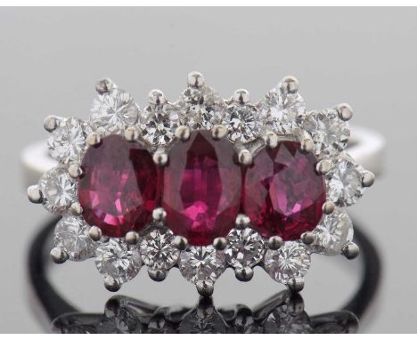 18ct white gold ruby and diamond ring design featuring three graduated rubies set within a brilliant cut diamond surround, di