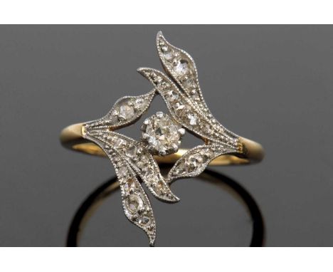 Diamond set ring centering an old cut diamond, 0.15ct approx, within a small diamond set leaf surround with milgrain edging, 